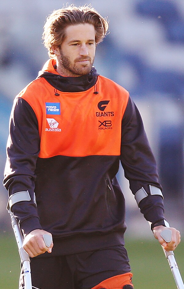 SLIDER-REHABREPORTRD5.png Callan Ward leaves the ground on crutches on Saturday. - AFL,GWS Giants,Callan Ward,Toby Greene,Ian Hill